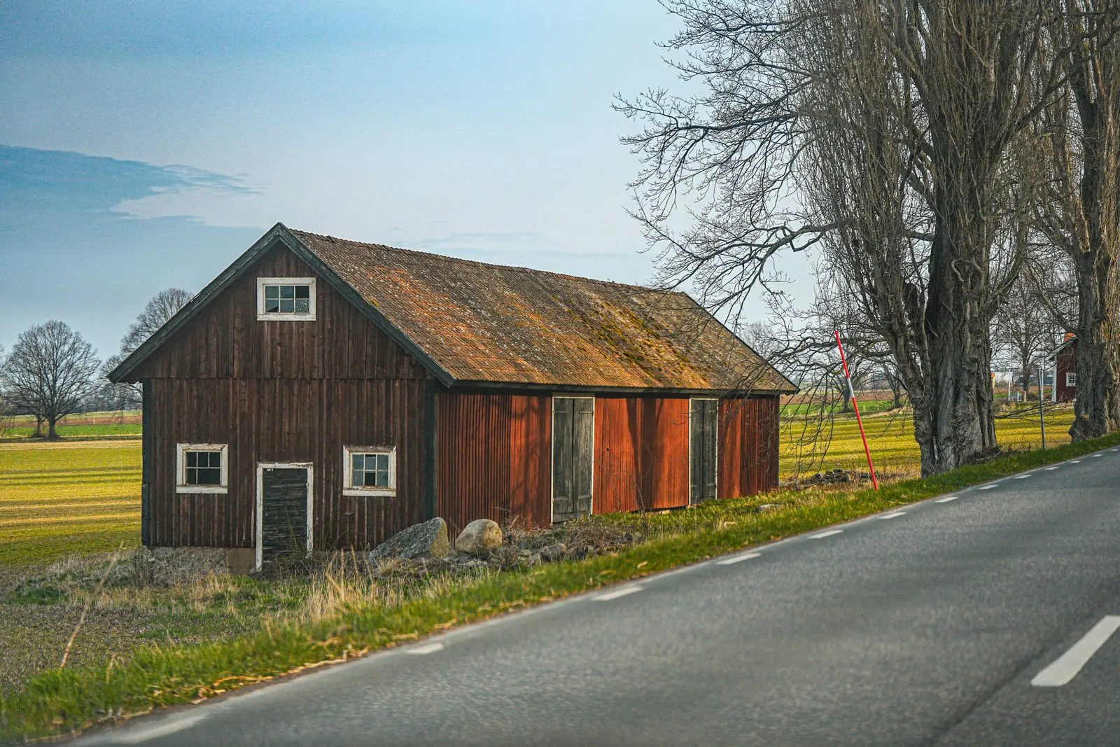 Red barn beside a country road