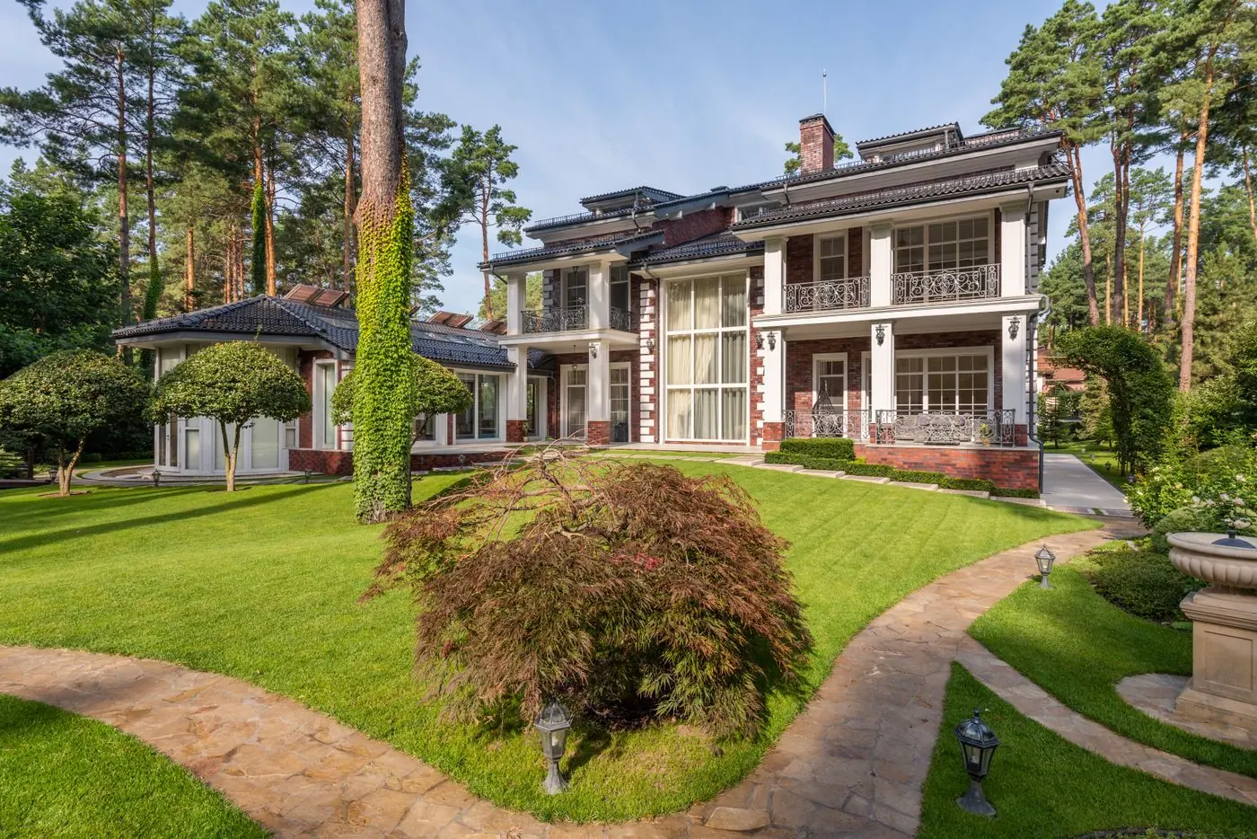 Home on a wooded lot with a lawn