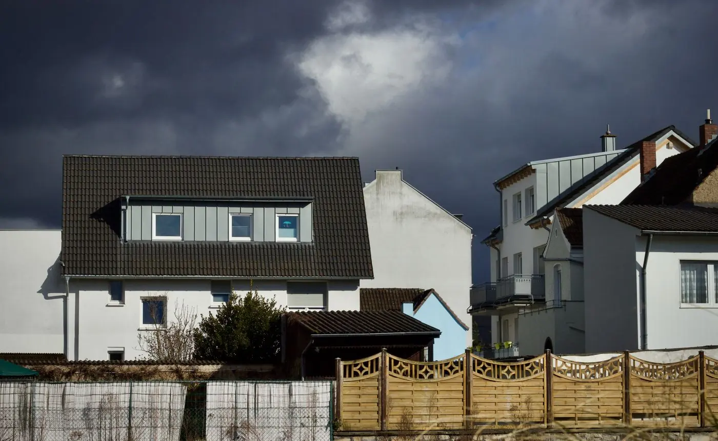 Dark storm sky over suburban houses
