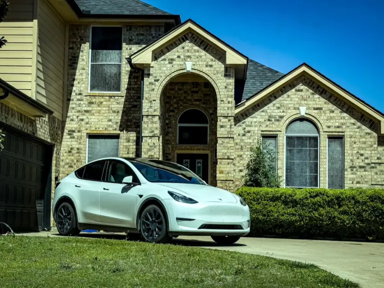 Stone-front home with a car parked in the driveway