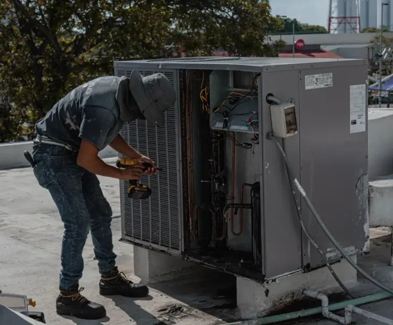 Technician servicing an outdoor unit