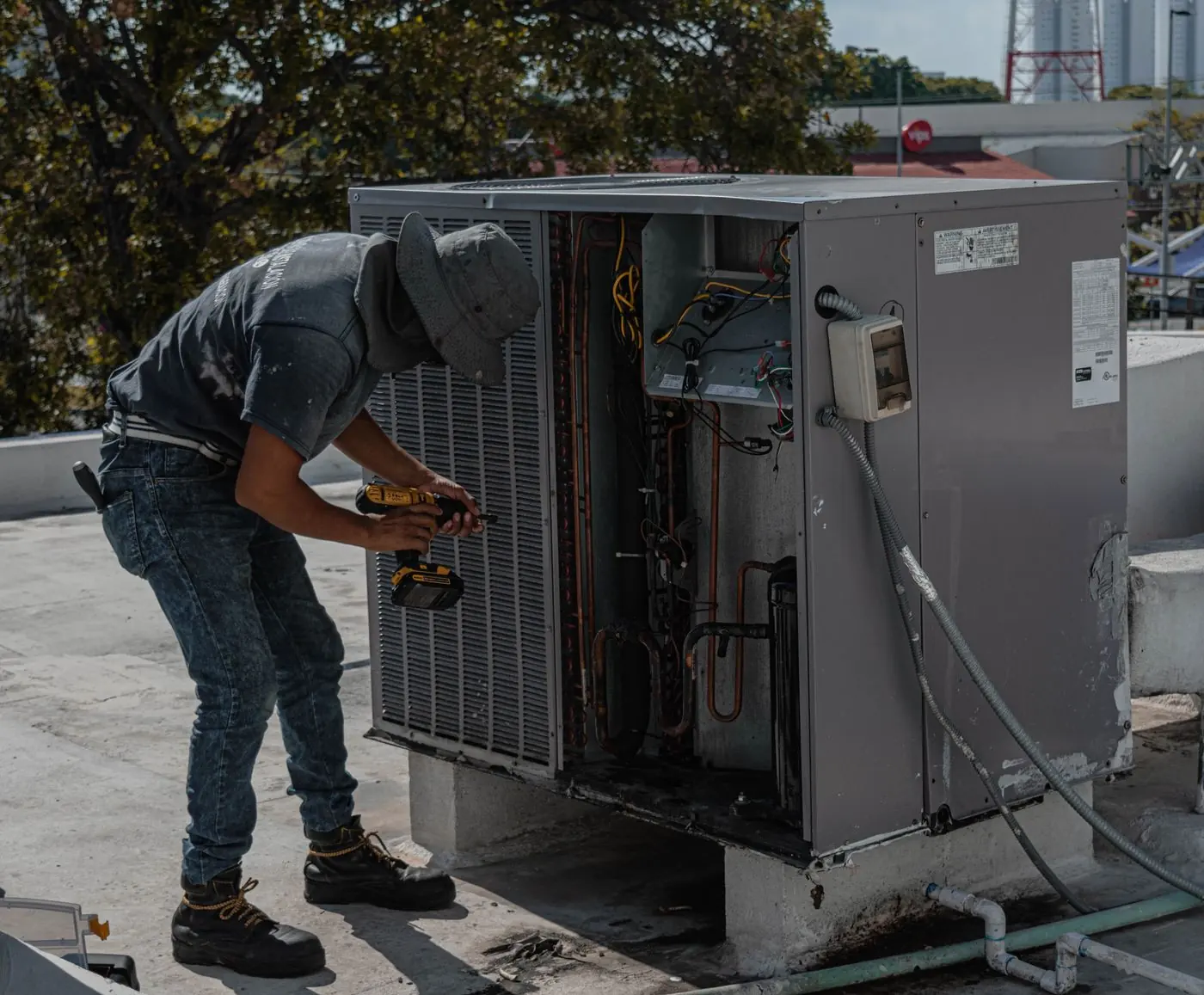 Technician servicing an outdoor unit
