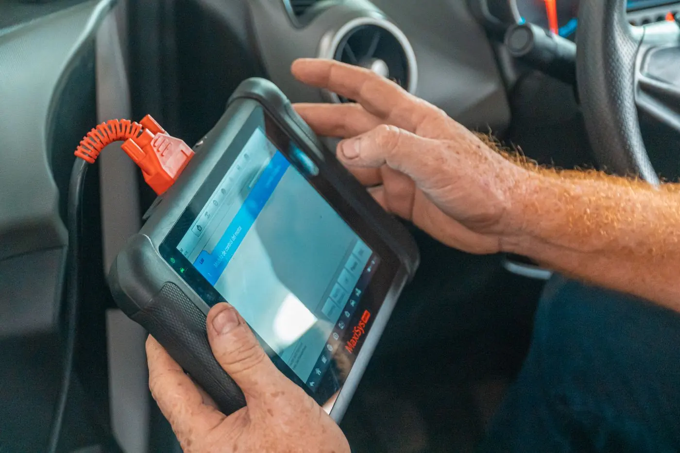 Technician running diagnostics on a tablet
