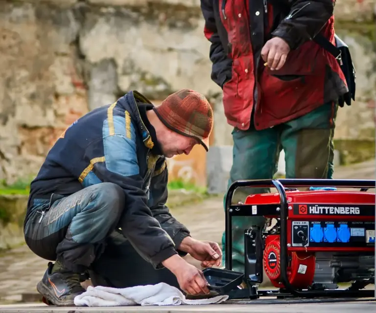 Technicians servicing a generator outdoors